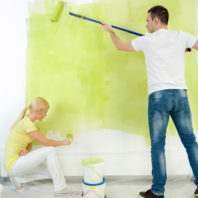 Couple together painting wall